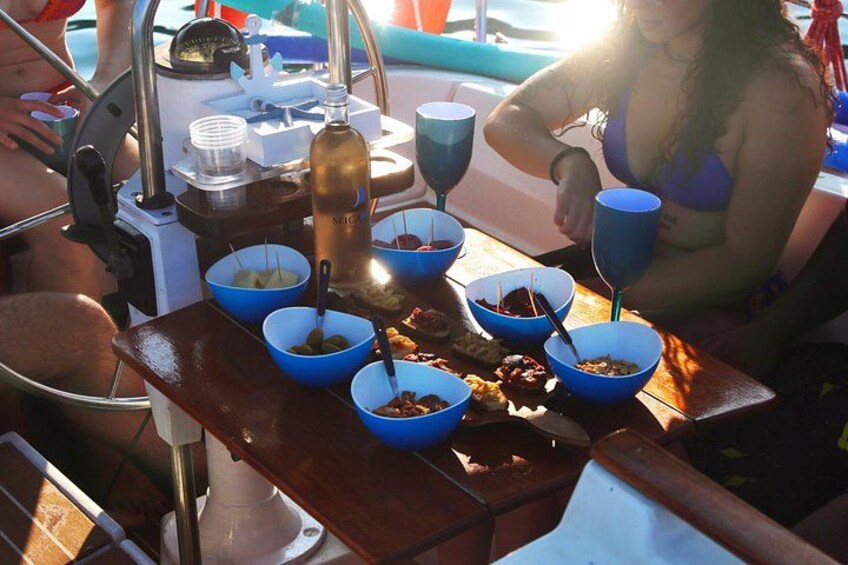 A table with blue bowls containing food, a bottle, and a scale. 2