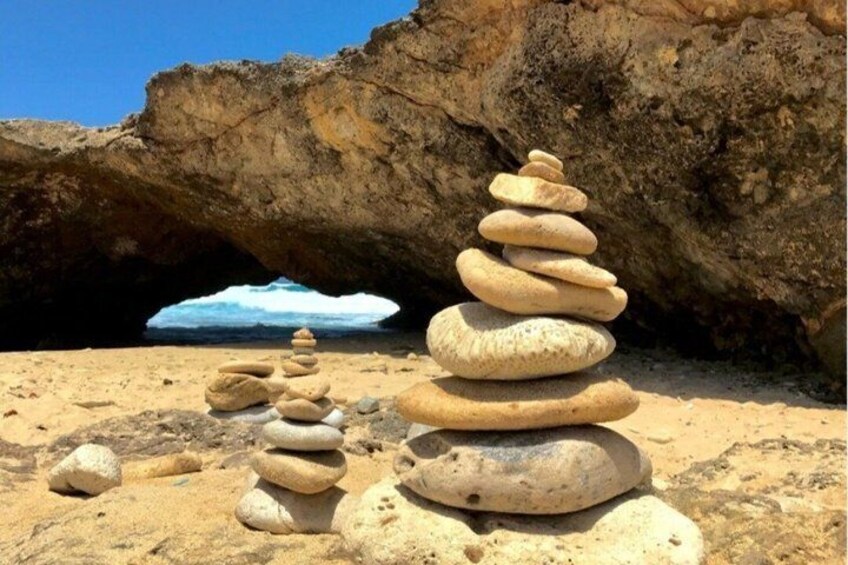 Stacked stones on a beach with a glacier in the background. 5