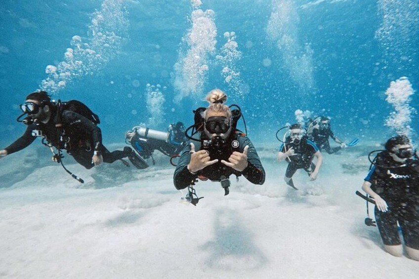 Scuba divers underwater with bubbles and bubbles rising to the surface. 2