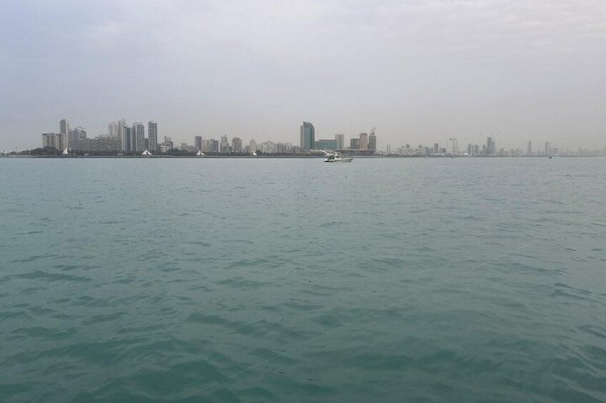 A coastal city skyline with buildings and a body of water. 3