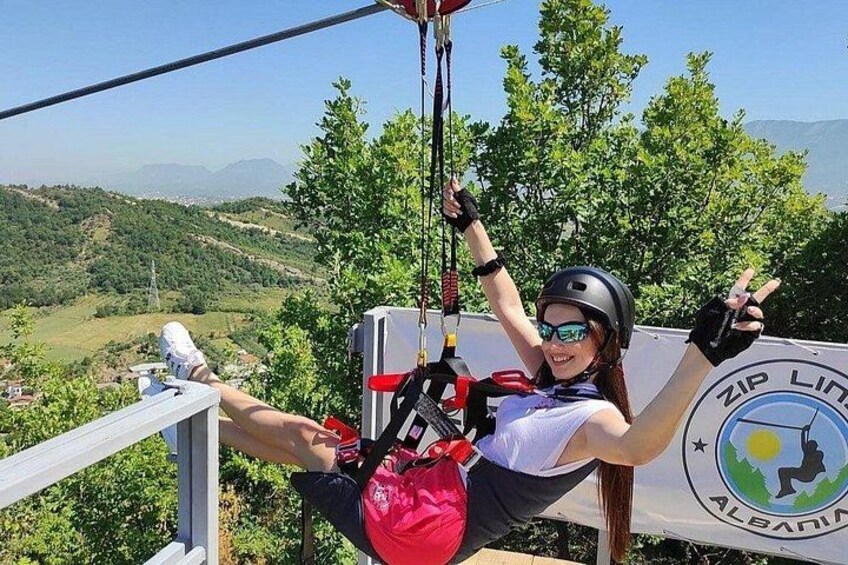 A person zip-lining with a scenic landscape in the background. 4