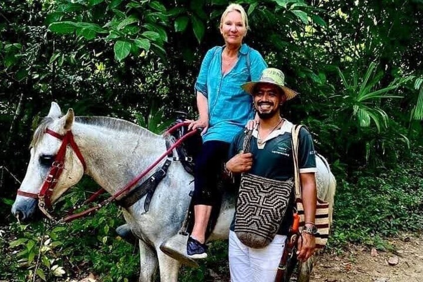 A person riding a horse in a forested area. 2