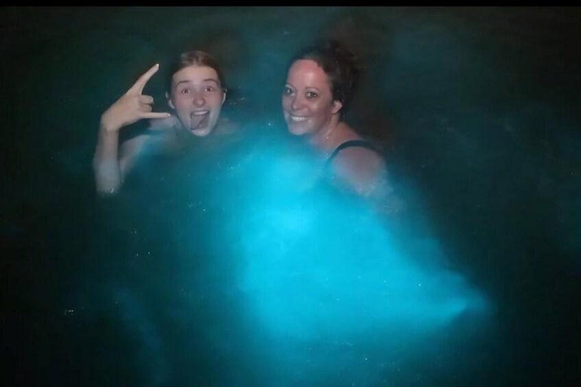 Two people in a body of water with a blue light effect. 3