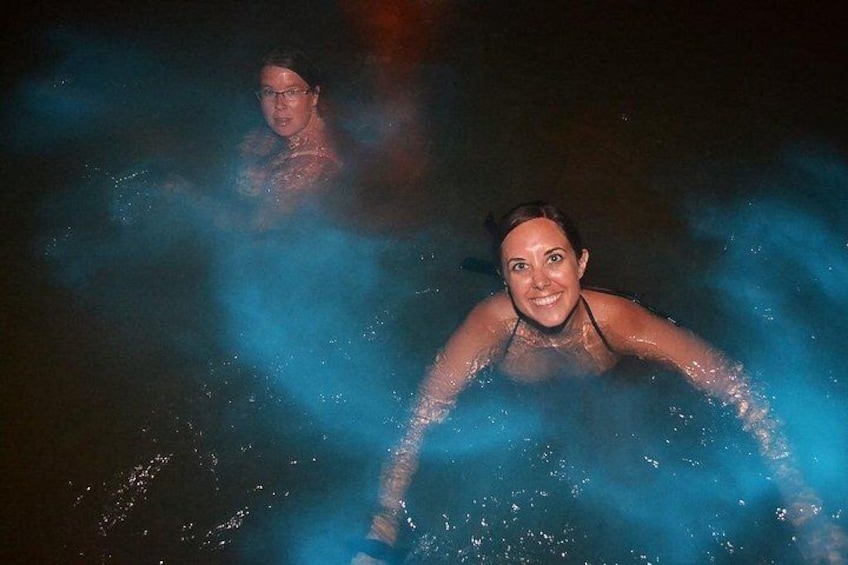 Two people in a hot spring with steam rising around them. 5