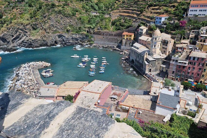 A coastal town with a harbor, boats, and historic buildings. 3
