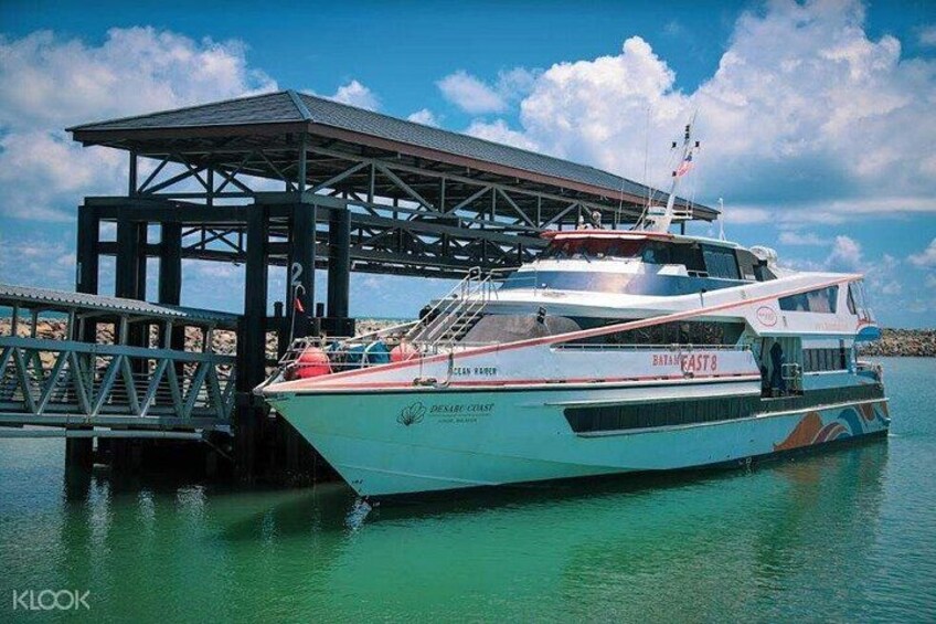 A white boat named 'BATH CAST 8' docked at a pier with a covered walkway. 2
