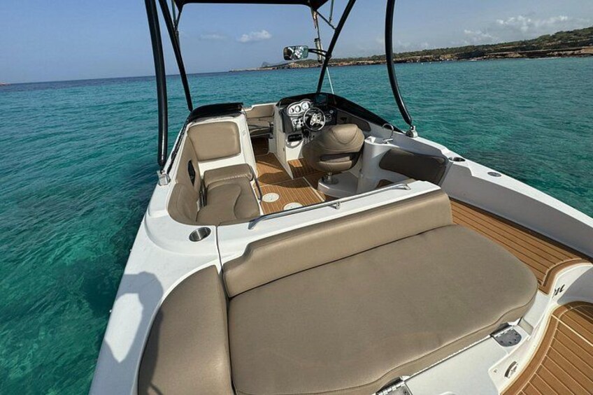 A boat's interior with seating and steering controls. 5