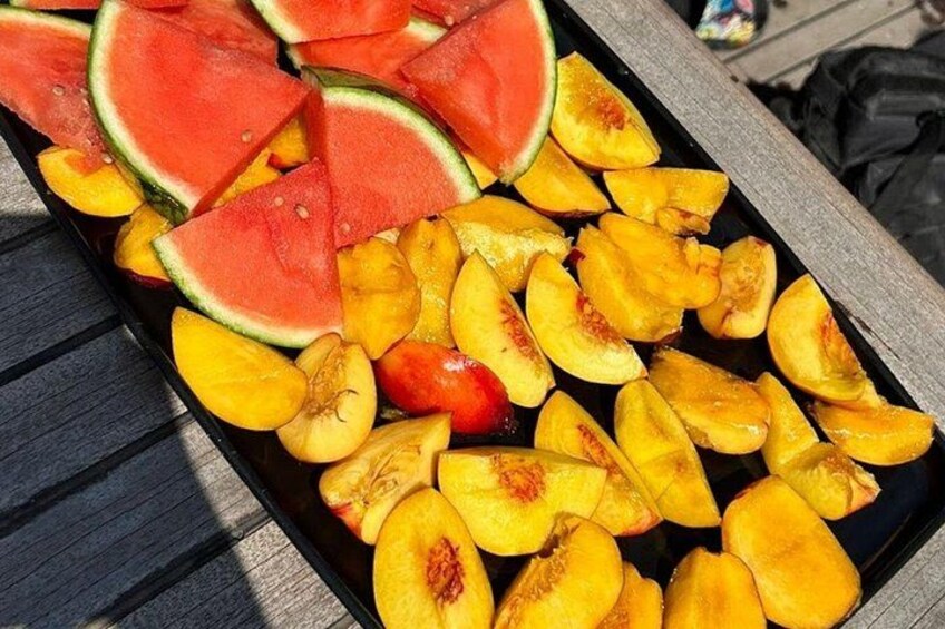 A tray of sliced watermelon and peaches. 4