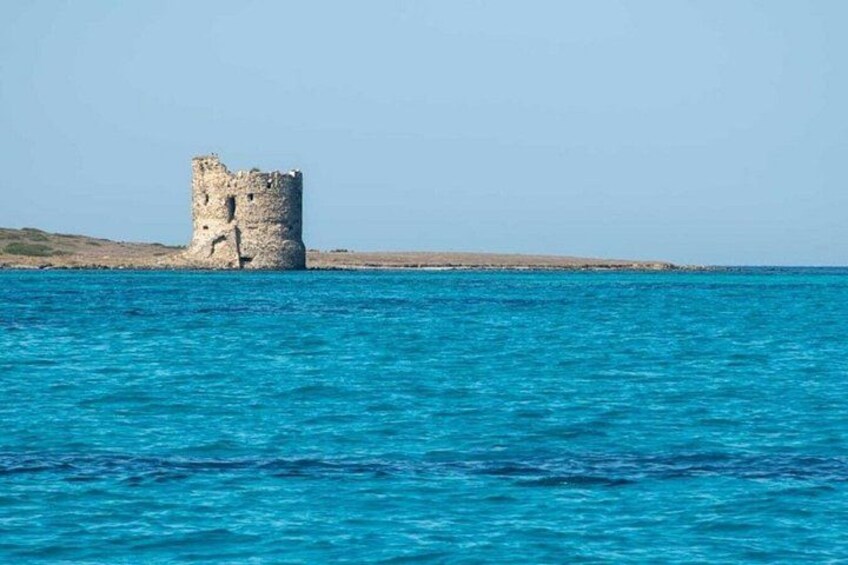 A coastal tower structure surrounded by turquoise sea. 5