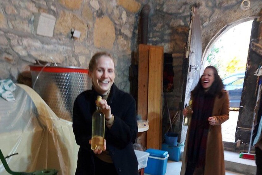 A rustic stone interior with a wine bottle and a tent. 2