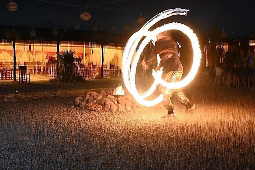 A person performing fire spinning with a large fire ring. 4