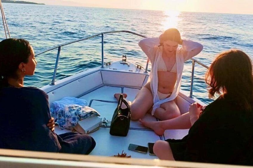 Ein Boot mit zwei Personen auf dem Deck, wobei eine Person ein Telefon hält. 4