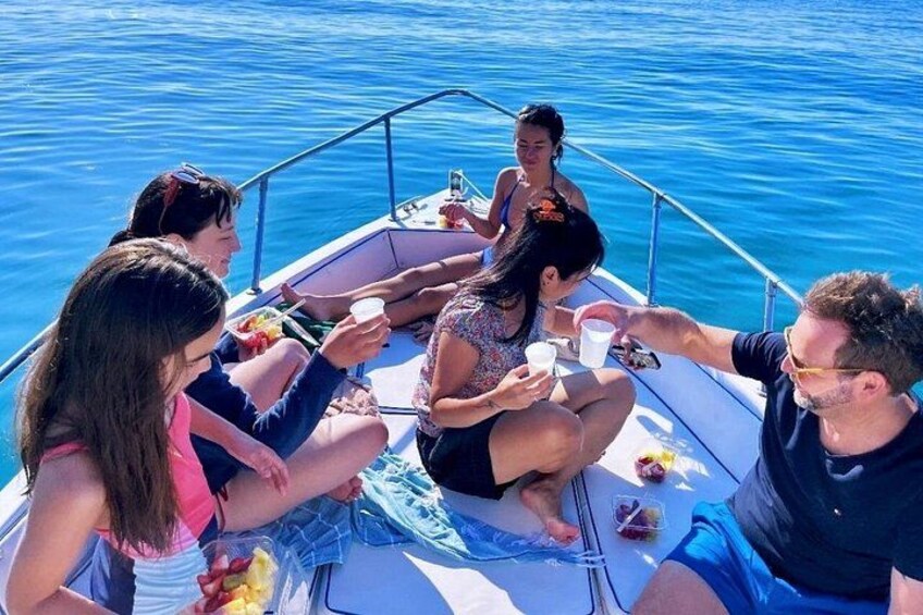 A group of people on a boat with water in the background. 4