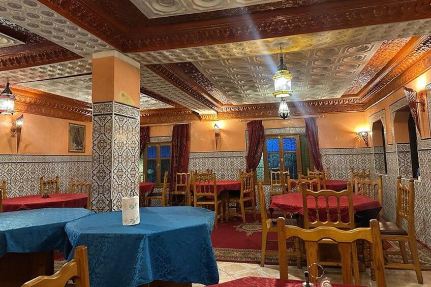 A traditional interior with ornate ceiling, patterned walls, and wooden furniture. 5