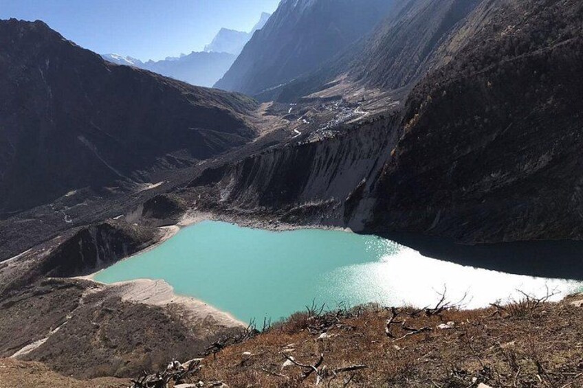 A turquoise lake surrounded by rugged mountains. 2