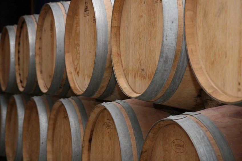 Wooden barrels stacked in rows. 4