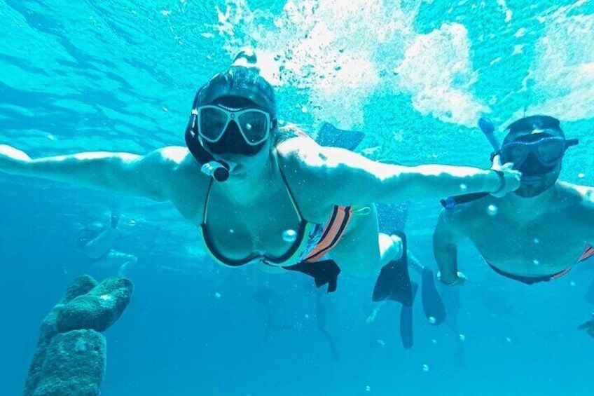 Two people snorkeling underwater. 2