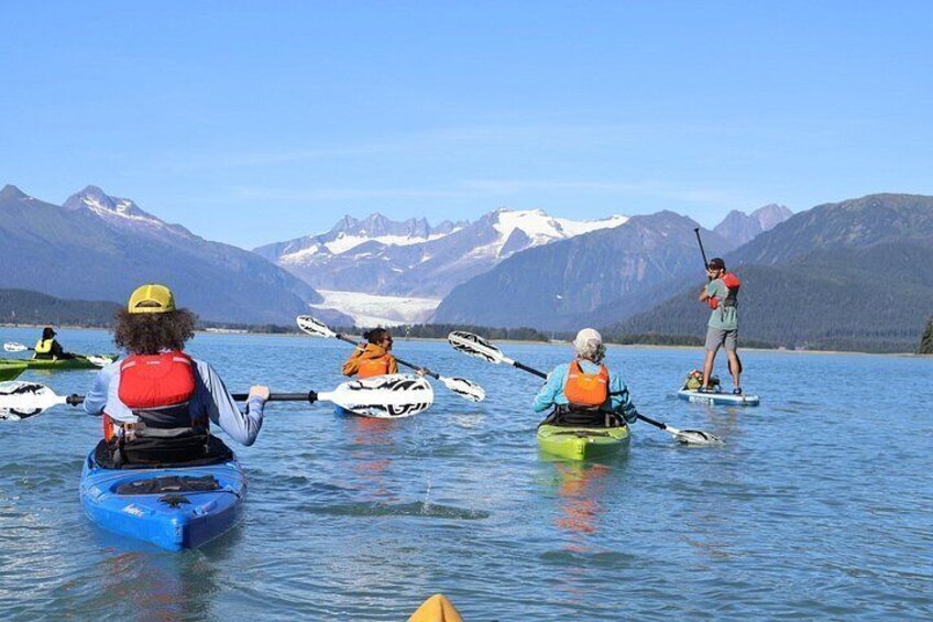 Persone che fanno kayak su un lago tranquillo con montagne sullo sfondo. 5