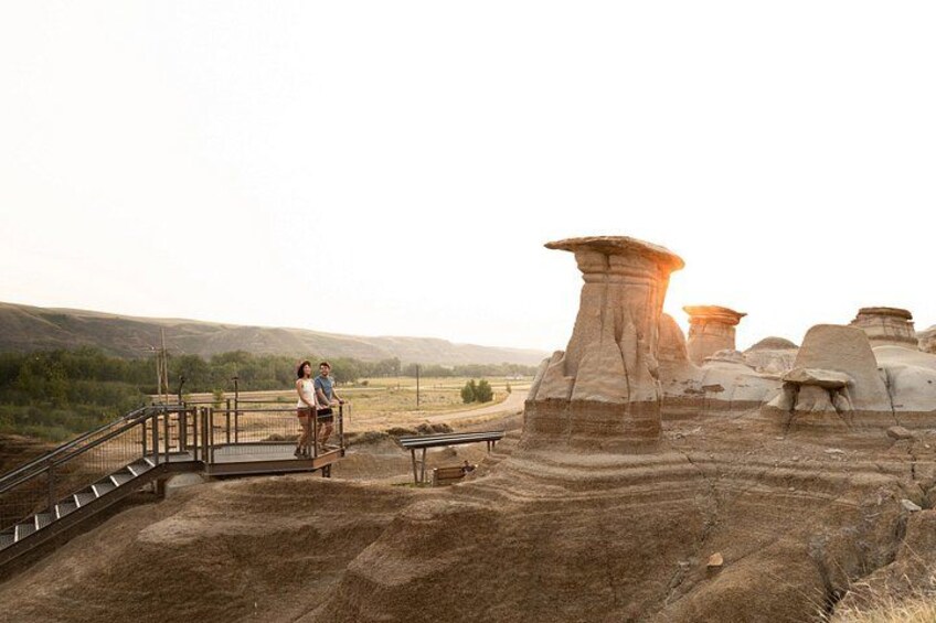 A landscape with unique rock formations and a viewing platform. 2