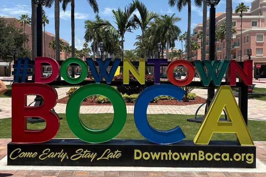 A colorful sign with the text 'Downtown Boca' and the website 'DowntownBoca.org'. 2