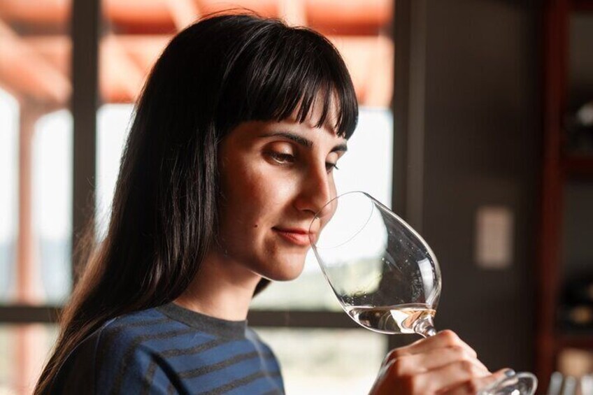 A person holding a wine glass. 2