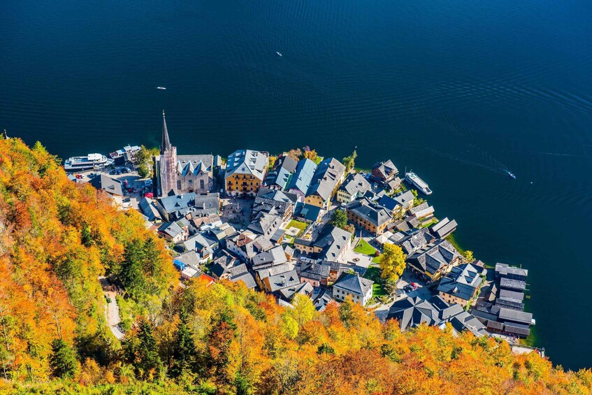 A coastal town with a church, houses, and boats on the water. 4