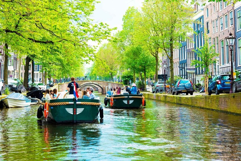A canal with boats, people, and historic buildings along the water. 3