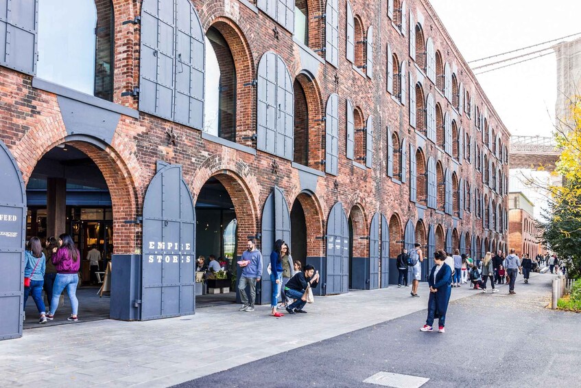 A brick building with arched windows and a sign that reads "Empire Stores." 4