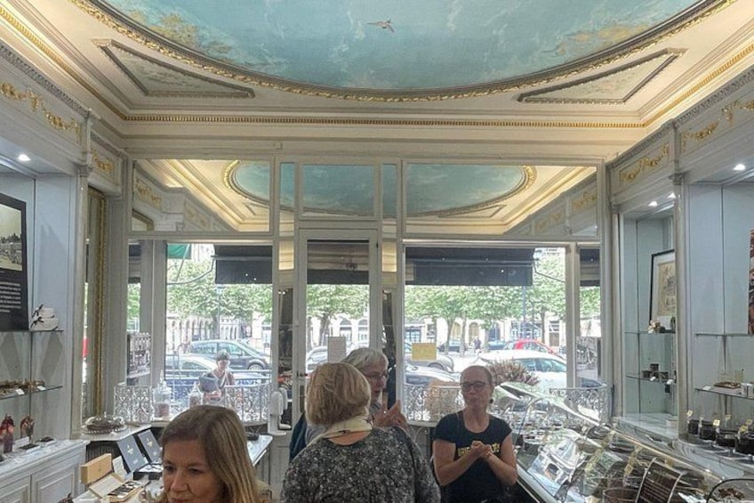 A jewelry store with ornate ceilings and large windows. 2