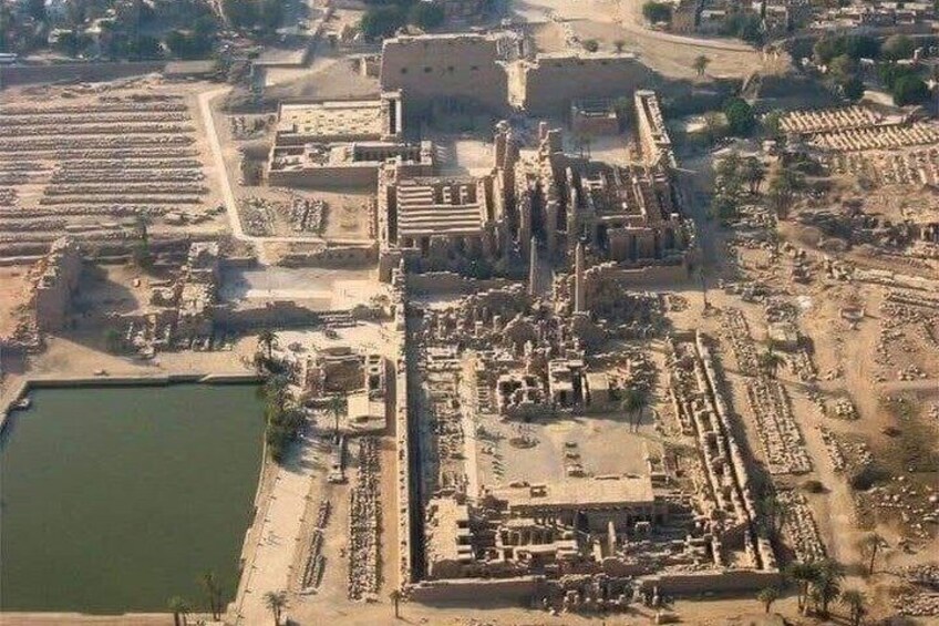 An aerial view of an ancient city with large ruins, a central building, and surrounding open areas. 4