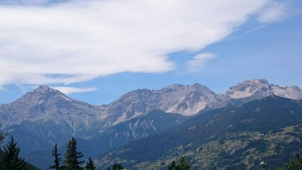 A mountain range with clear skies and some clouds. 5