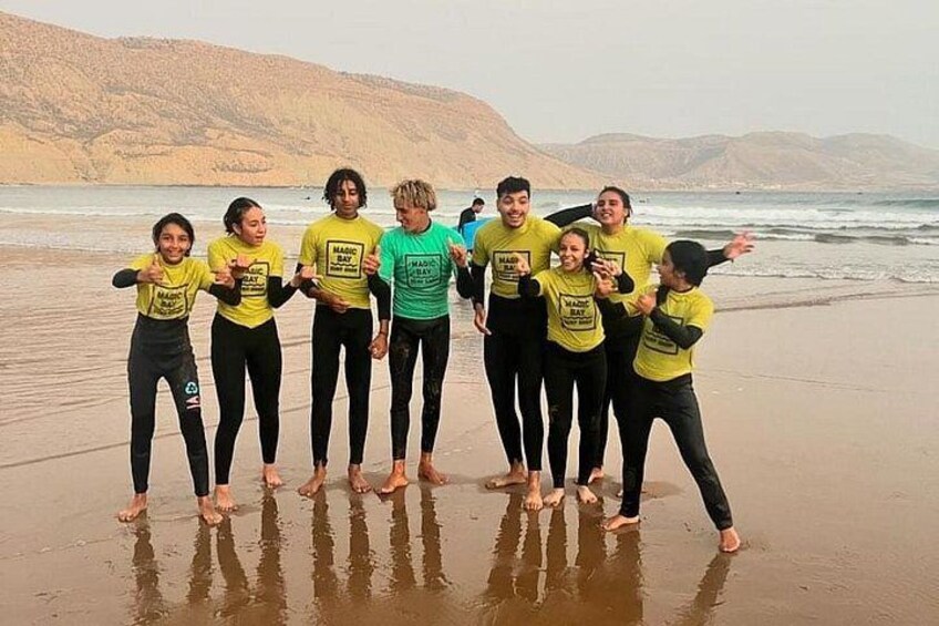 A group of people on a beach with a hilly landscape in the background. 3