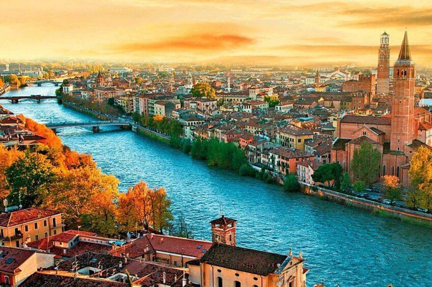 A river winding through a city with historic buildings and a prominent tower. 5