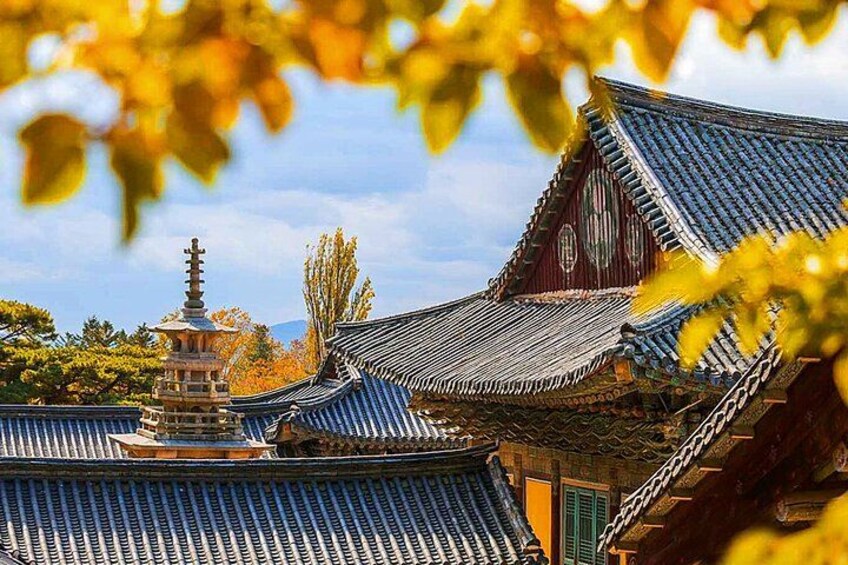 Traditional Korean architecture with tiled roofs and a pagoda. 1
