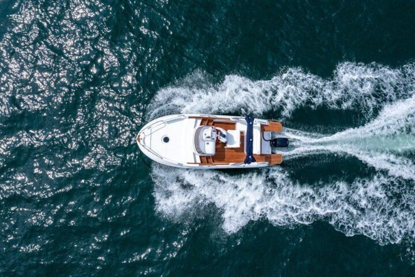 A boat moving through the water, creating a wake behind it. 2
