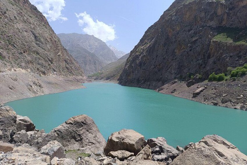 A turquoise lake surrounded by rocky mountains. 4