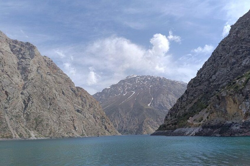 A mountain lake with rocky cliffs and a clear sky. 5