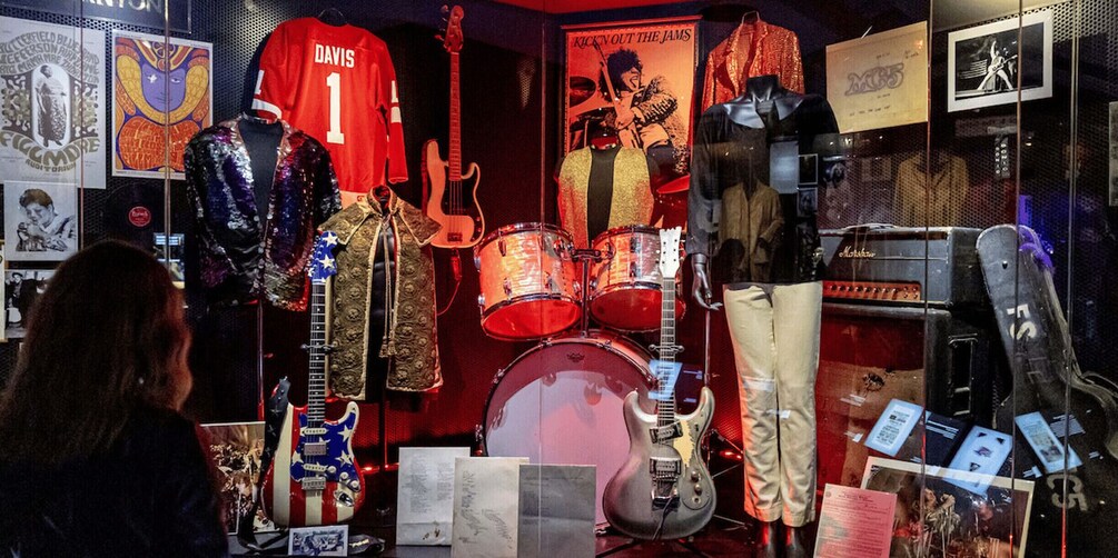 A music store with guitars, drum sets, and band merchandise. 5