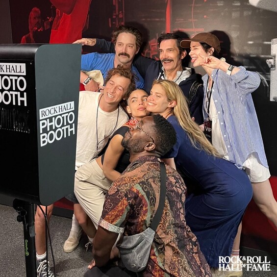 A group of people posing for a photo at a Rock Hall photo booth. 3