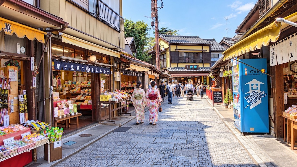 A traditional Japanese street with shops and a vending machine. 5