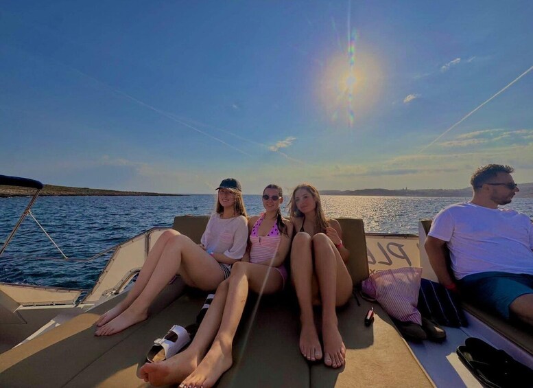 A group of people on a boat with a clear sky and calm sea. 3