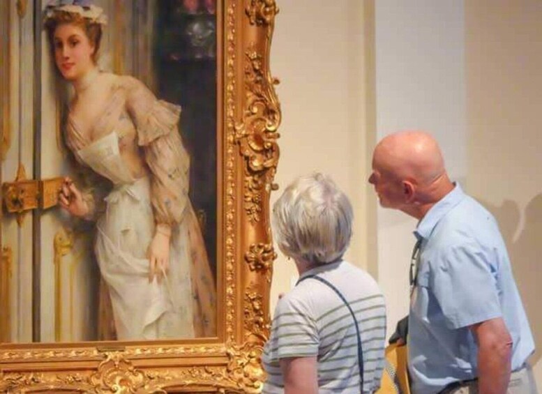 A person examining a large, ornate painting in a museum. 3