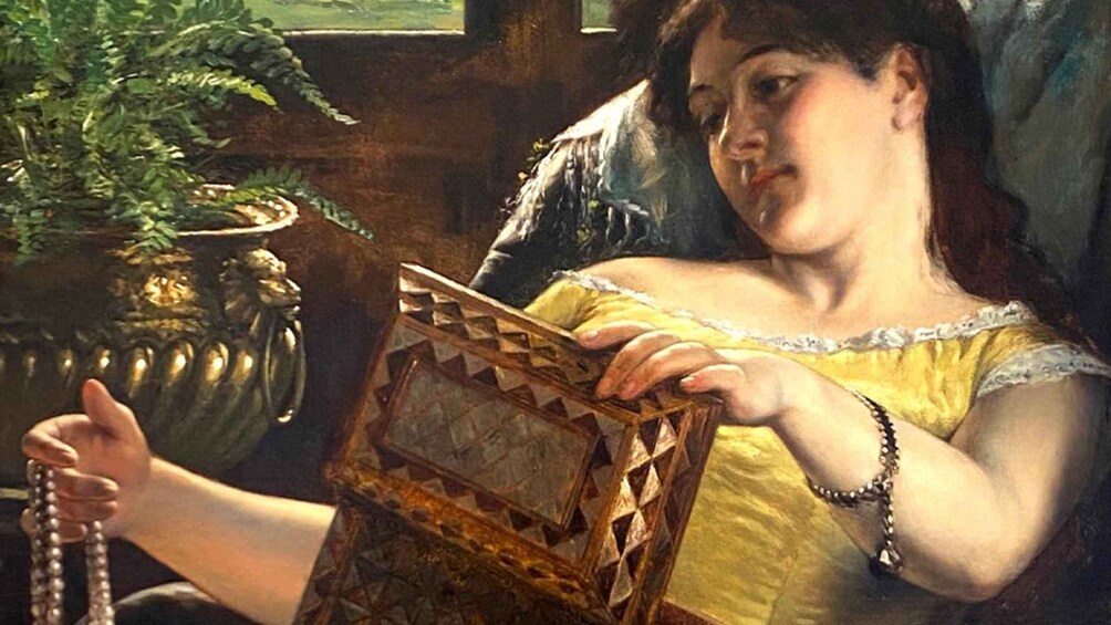 A person reading a book in a room with a potted plant. 4
