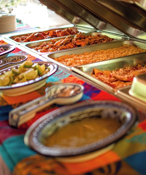 A buffet with various food items including pasta, salads, and other dishes. 2
