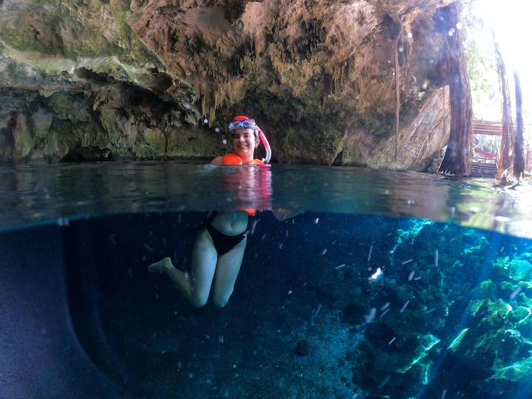 A person swimming underwater in a cave. 1