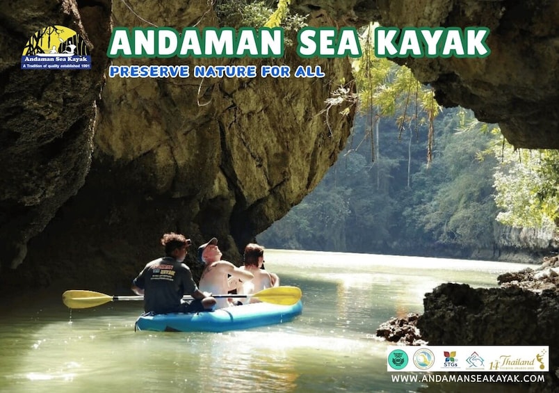 A group kayaking through a cave opening surrounded by lush greenery. 3