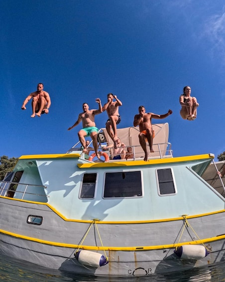 People jumping off a boat into the water. 3