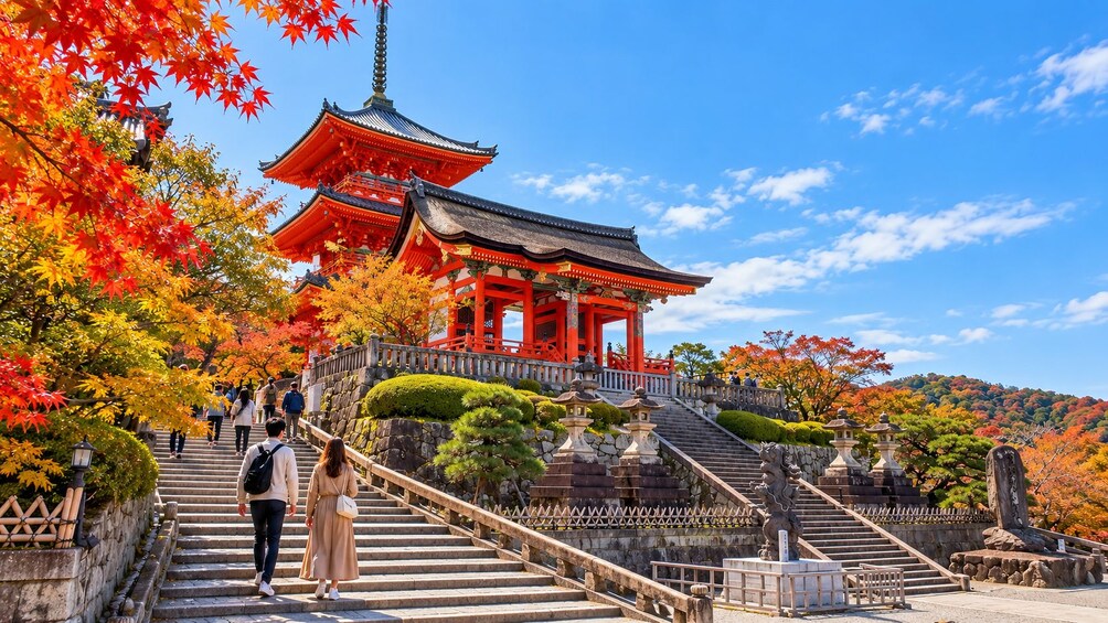 A traditional Japanese pagoda with red and white colors, surrounded by autumn foliage and stone steps leading up to it. 1