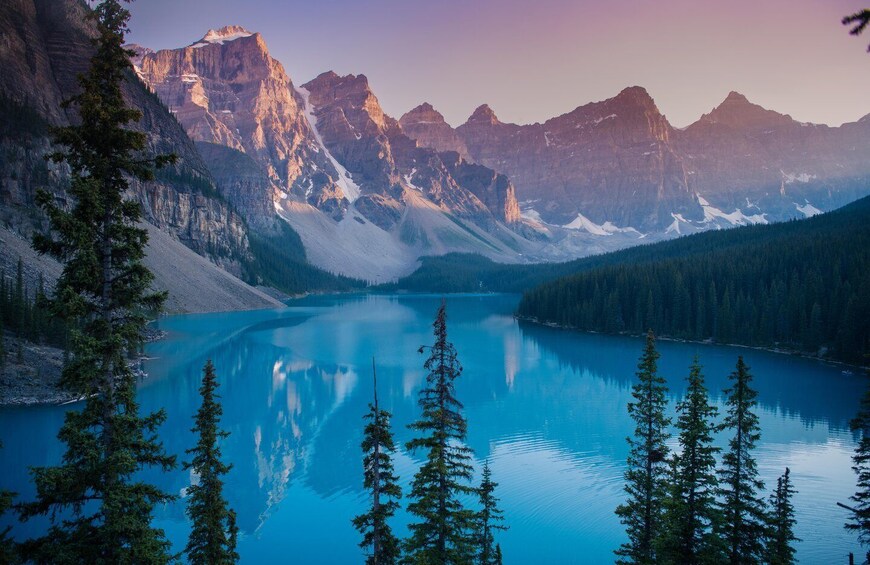 A mountain lake surrounded by forest and mountains. 1