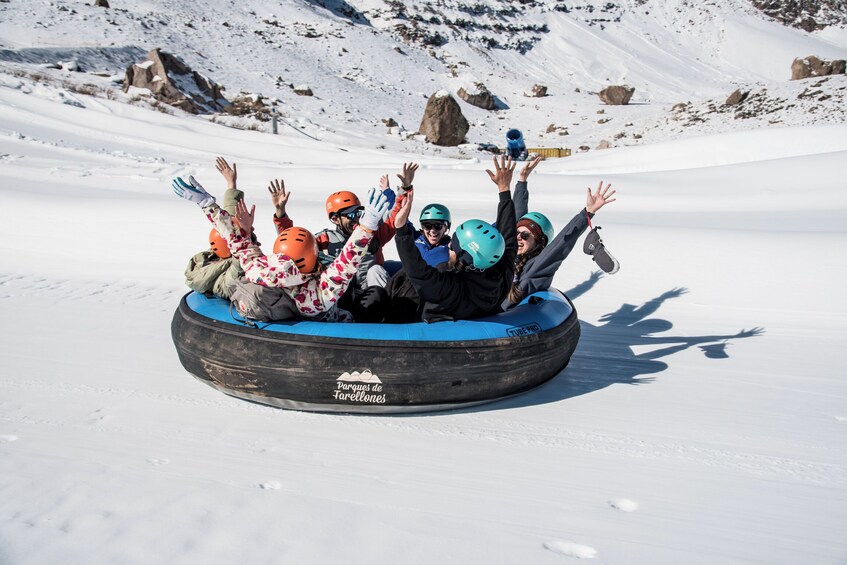 A group of people on a snow tubing ride at Parcues de Tarrellones. 1